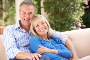 smiling older couple relaxing at home