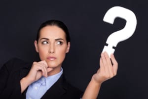 woman in business suit holding a question mark