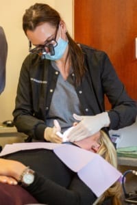 dental hygienist working on patient