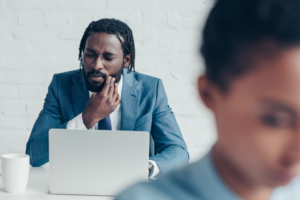 businessman with laptop experiencing toothache pain