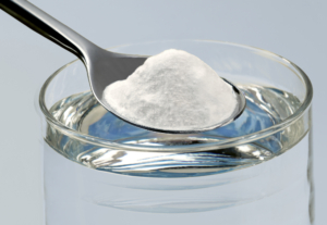 spoonful of salt over glass of water