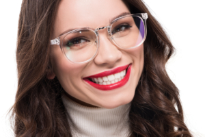 woman with glasses showing off a smile with porcelain crowns