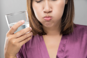 woman rinses mouth with salt water