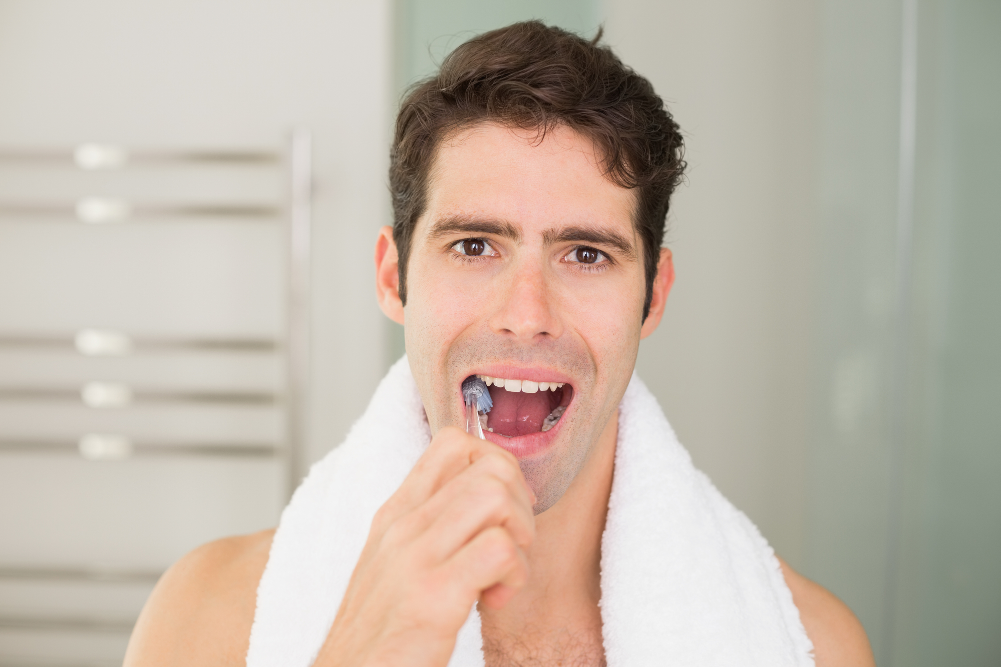 close up of man brushing teeth