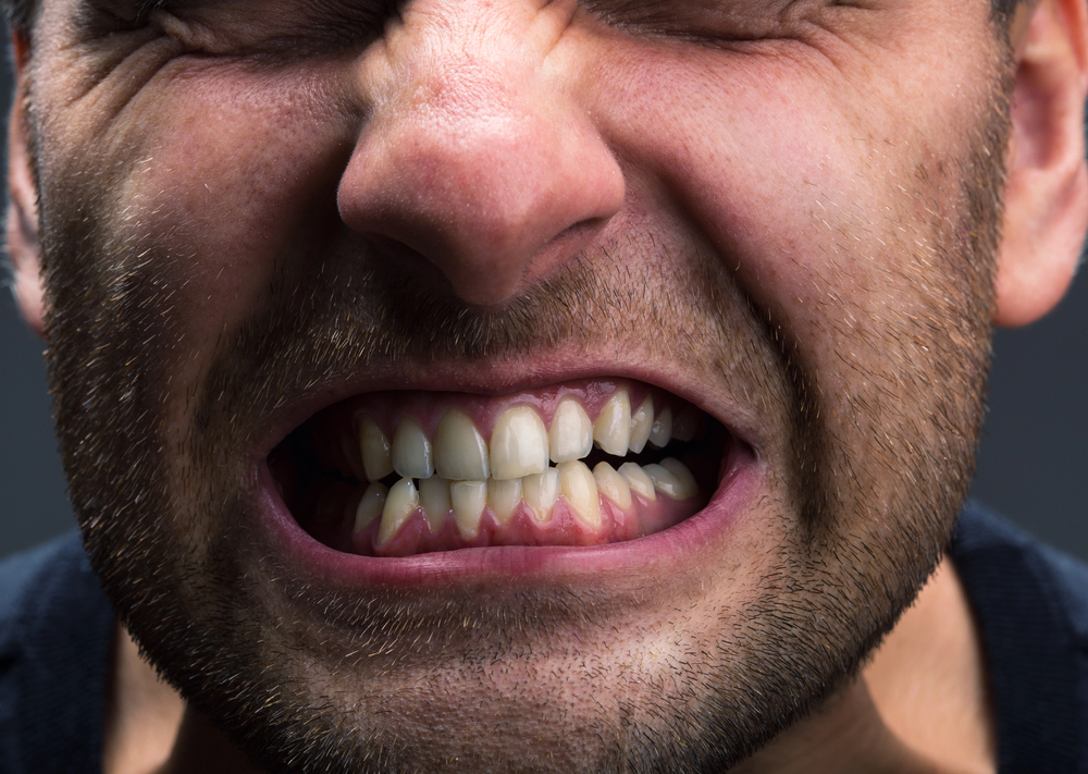 close up of man grinding his teeth